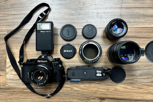 Nikon EM S# 6373218 with Nikon Lens Series E 50mm S# 1357883, Nikon Lens Series E 100mm S# 1808117, Nikon Lens Series E Zoom 75-150mm S# 3056074 and Nikon SB-E Speedlight