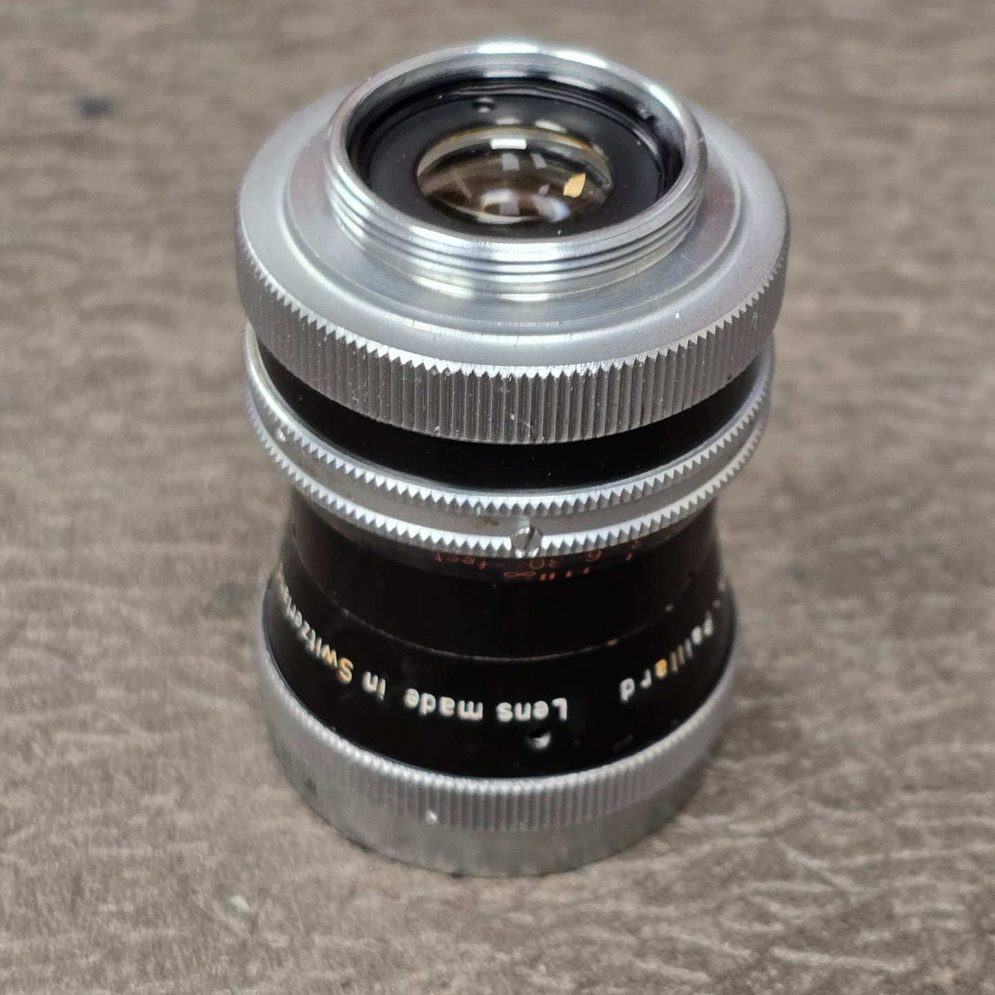 Switar 10mm f1.6 C-Mount Lens S# 1037028 with Bolex Series 6 Lens Shade