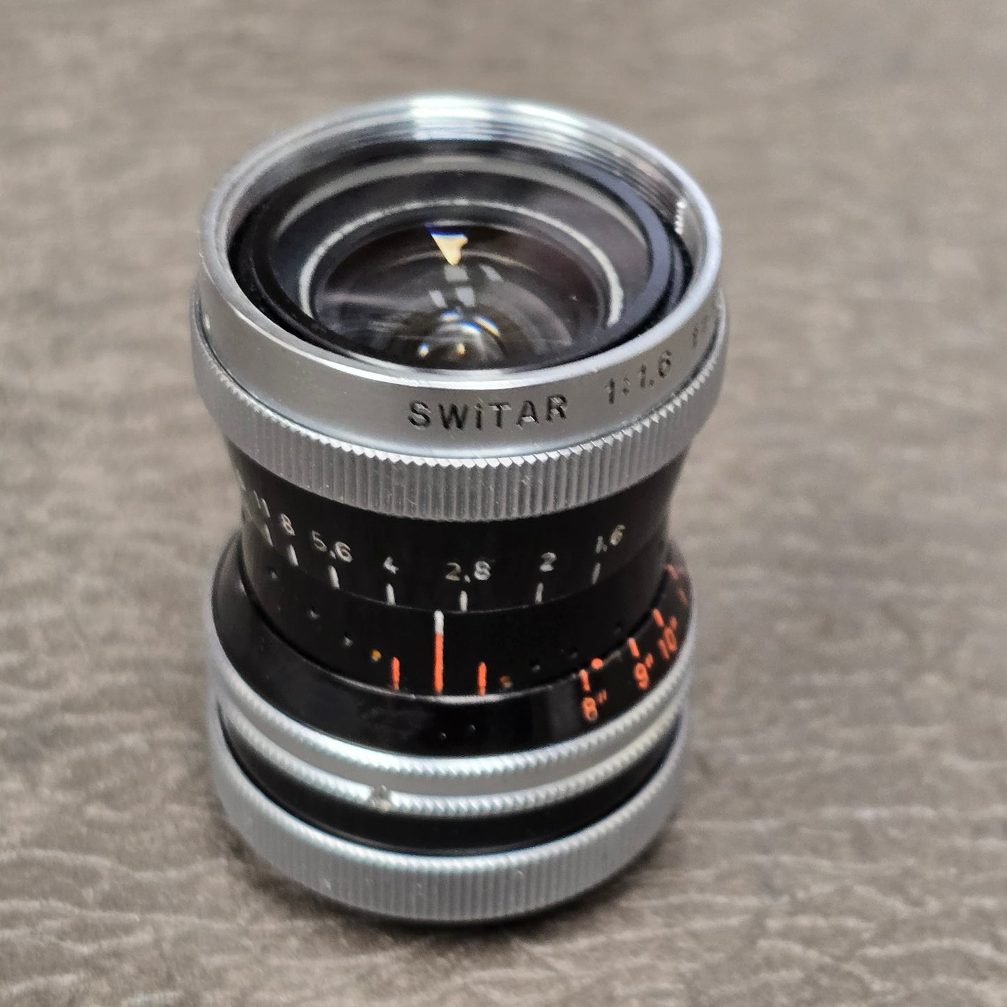 Switar 10mm f1.6 C-Mount Lens S# 1037028 with Bolex Series 6 Lens Shade