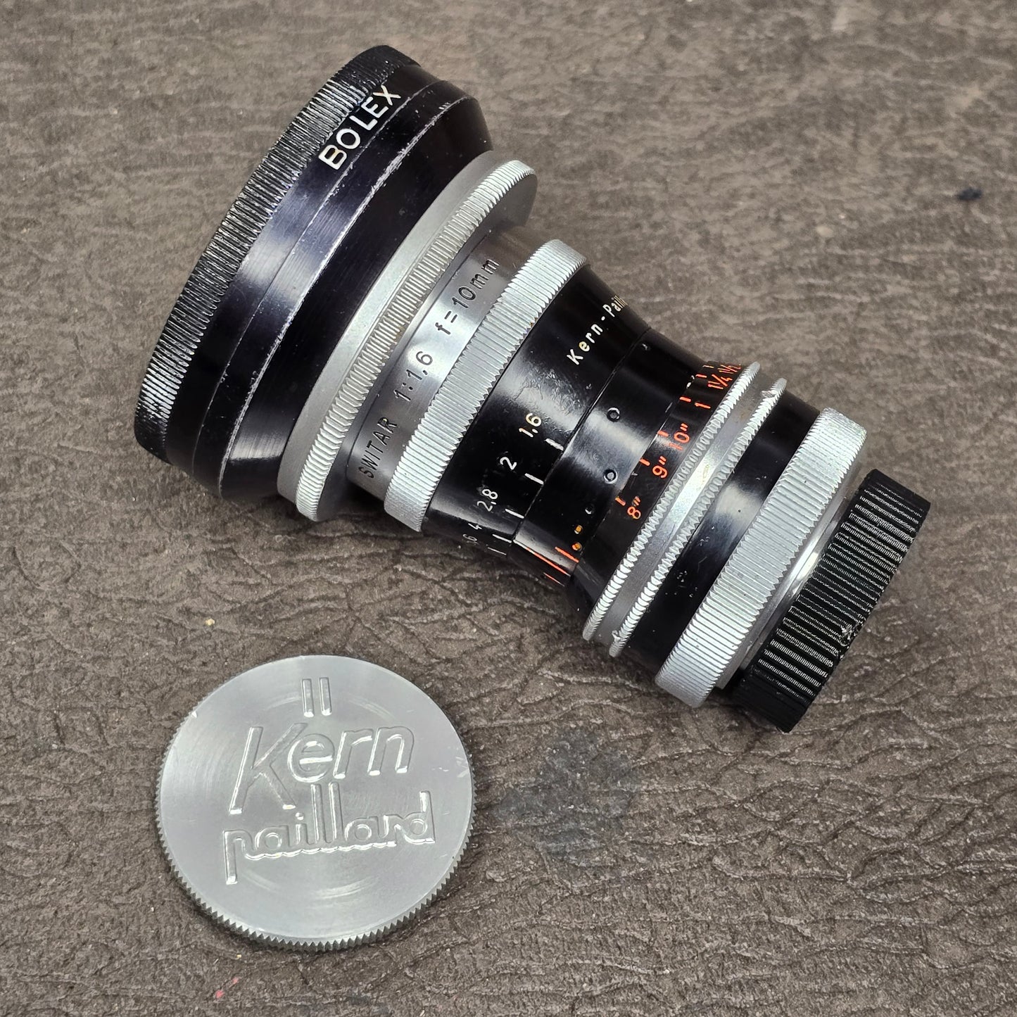 Switar 10mm f1.6 C-Mount Lens S# 1037028 with Bolex Series 6 Lens Shade